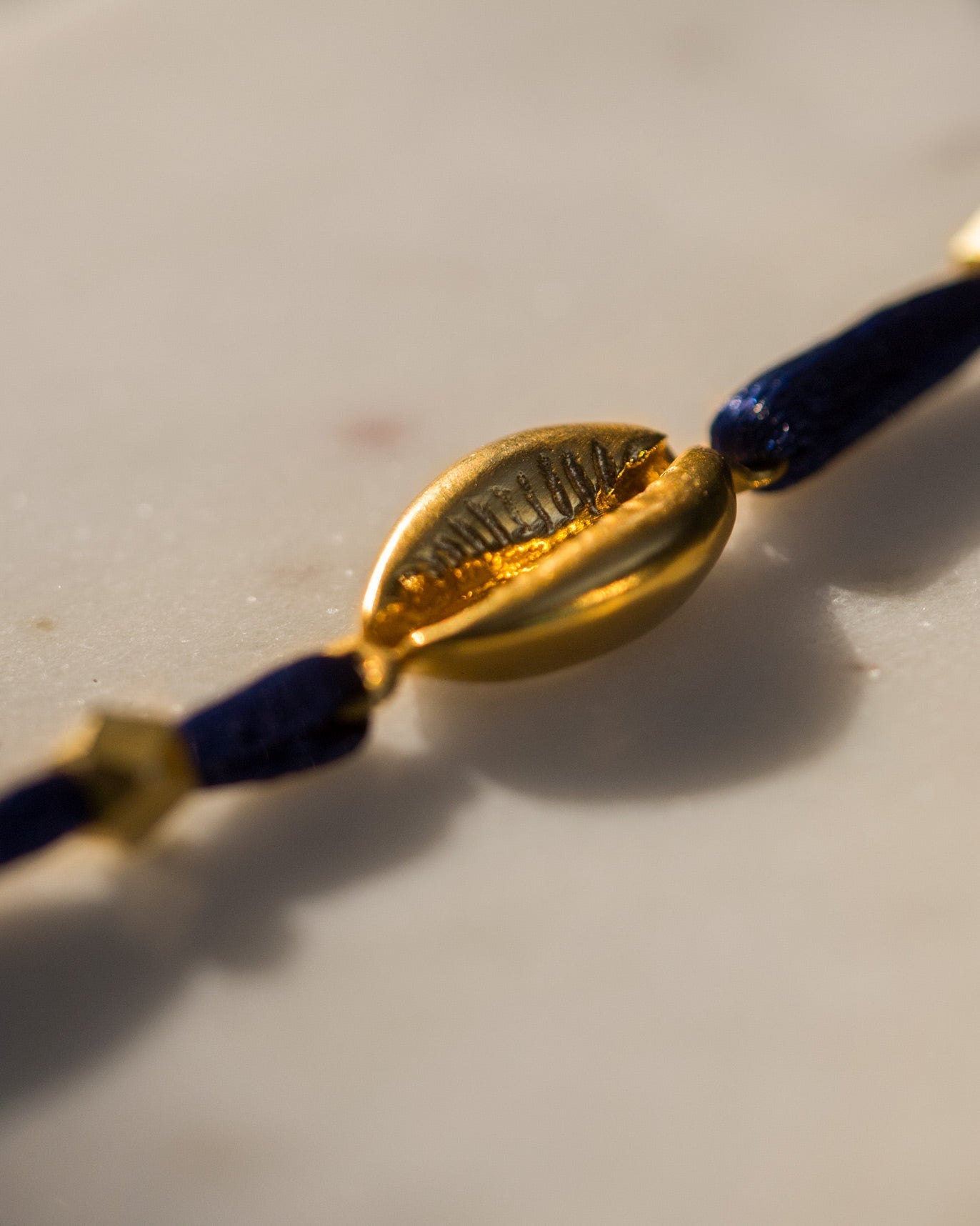 Cowri Rakhi - Gold