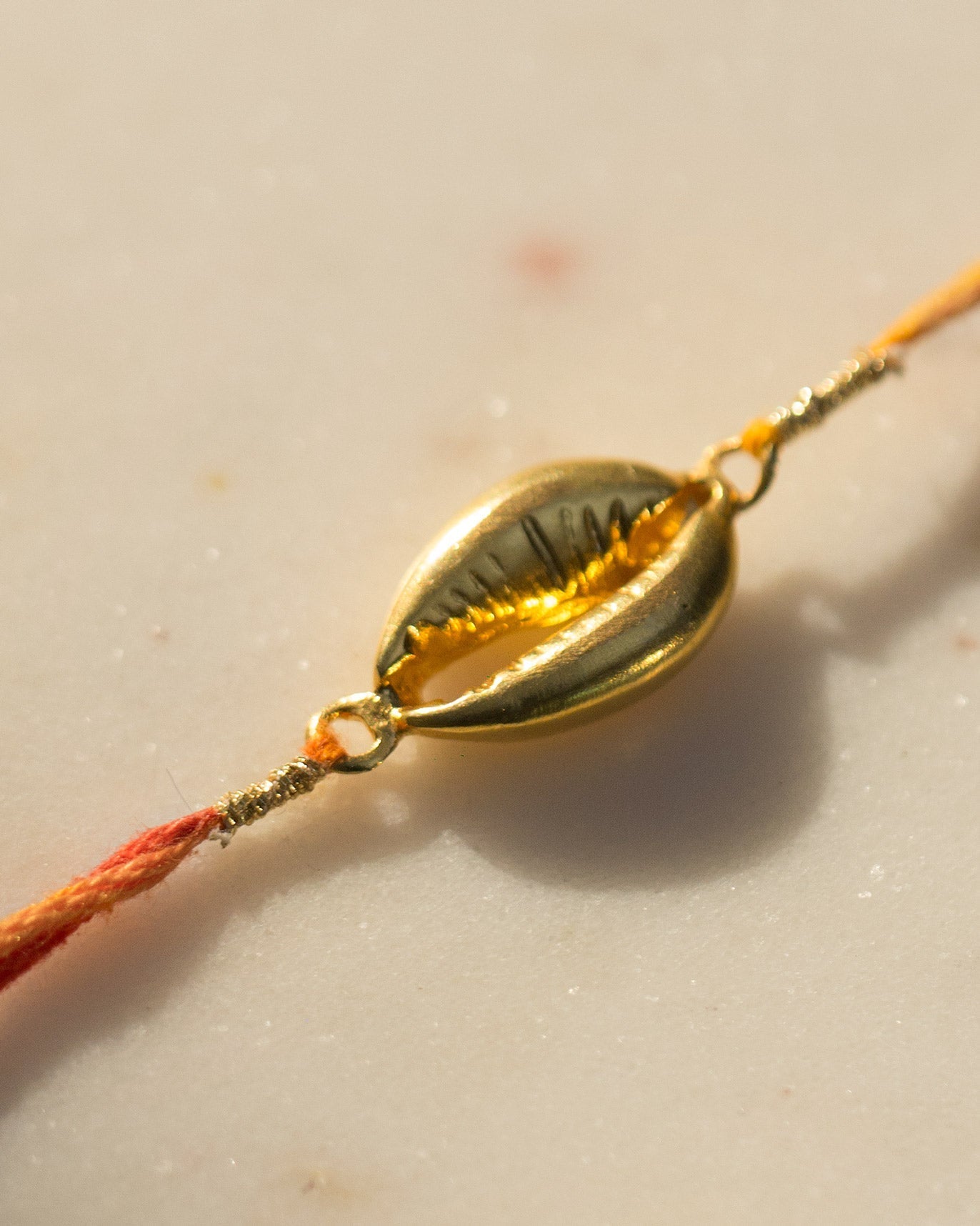 Cowri Rakhi - Saffron